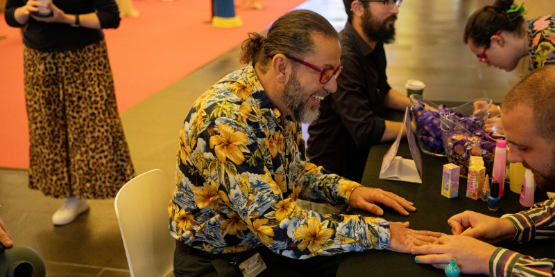 One person painting the nail of another