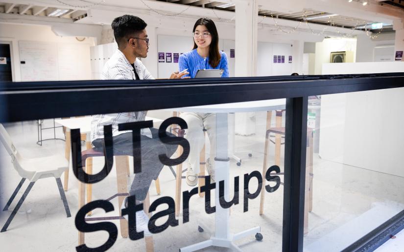 A man and a woman seated in the UTS Startups coworking space. Picture by Andy Roberts