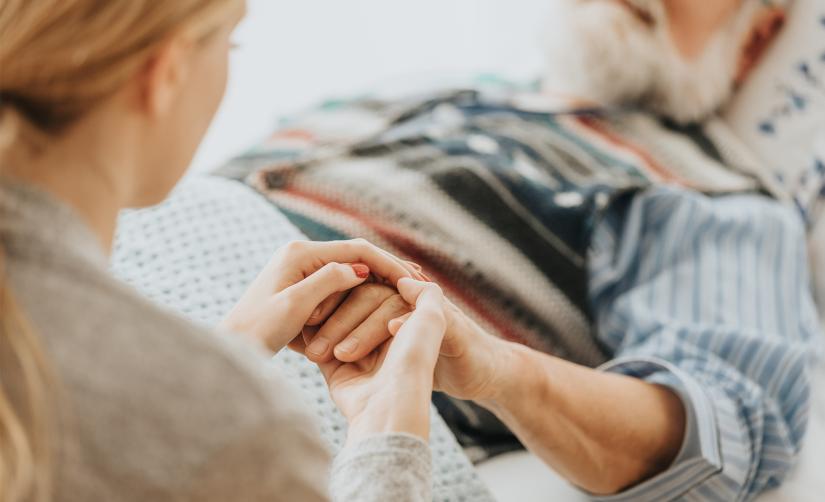 Photo of person in hospital bed receiving care