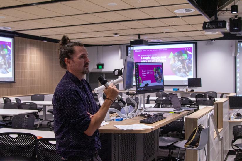 A man presents to a classroom full of students