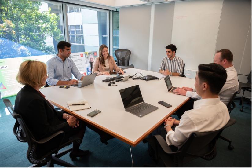 Students meet around a table