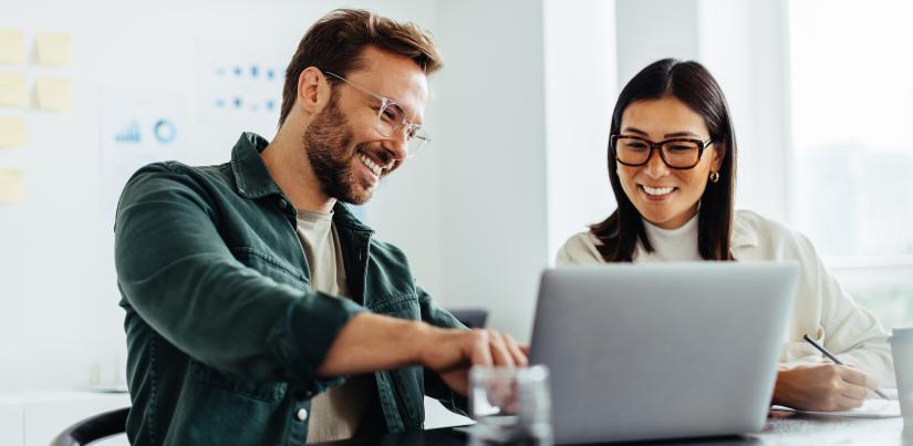 Photo of two people using a computer