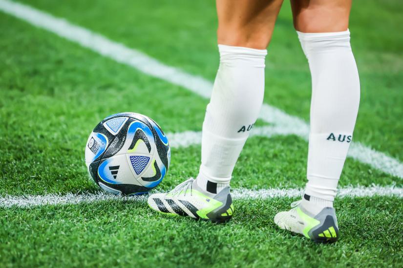 Close up shot of the legs of a football player on the point of kicking the ball. Picture: Adobe Stock