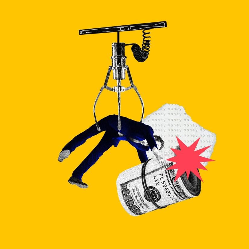 A man in a vending machine tries to hold onto a wad of cash