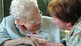 Elderly woman with carer. Flickr photo by McBeth