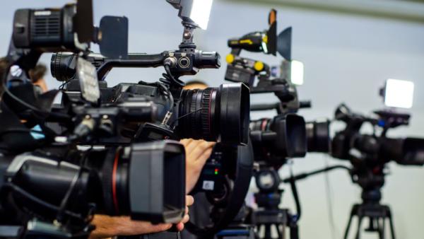 Reporters are filming on TV cameras