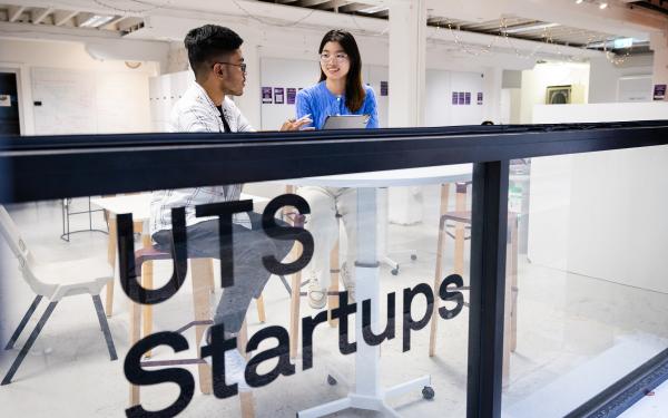A man and a woman seated in the UTS Startups coworking space. Picture by Andy Roberts