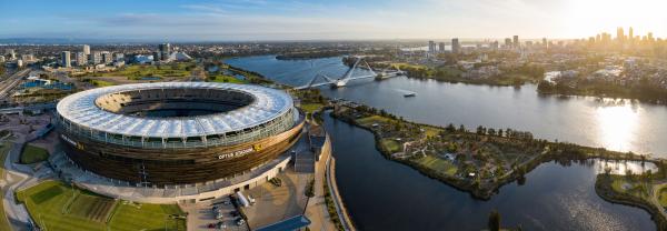 Panoramic aerial view of the Optus stadium and Matagarup bridge with the city of Perth, Western Australia in the background at sunset