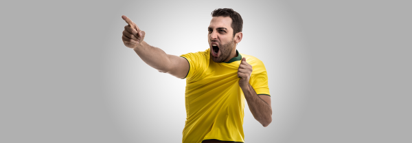 Football player grabbing jersey and yelling at crowd