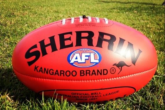 A Sherrin AFl football on grass.