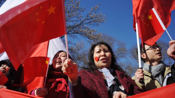 800x450%20Chinese%20holding%20China%20flags