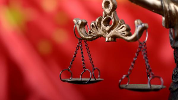 800x450%20Lady%20Justice%20in%20front%20of%20the%20flag%20of%20China_0