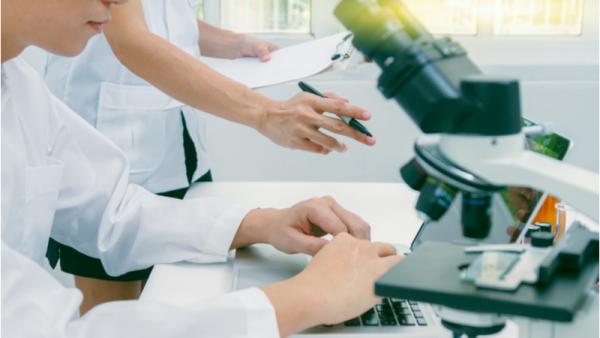 800x450%20Scientists%20researching%20using%20laptop%20and%20microscope
