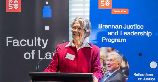 Madeline Brennan KC speaks on stage