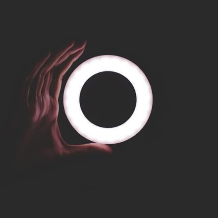 Hand around glowing ring