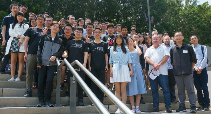 Participants from the Quantum Computer Science School standing on steps as a group