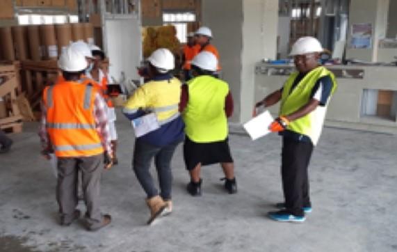 Workers in high vision jackets amidst intense deliberation