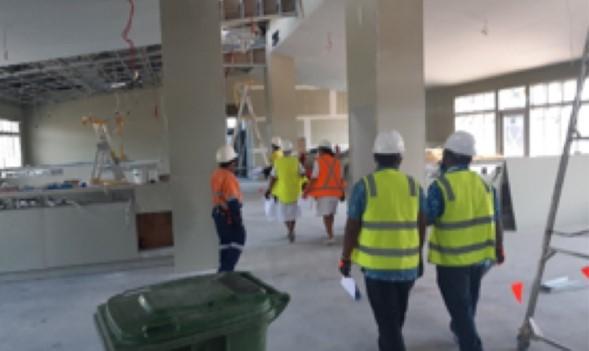 Workers in high vision jackets moving on from previous arena