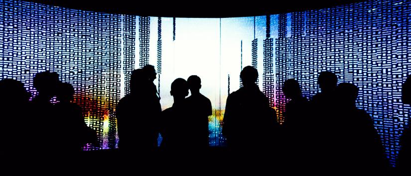 Silhouetted people inside the UTS Data Arena