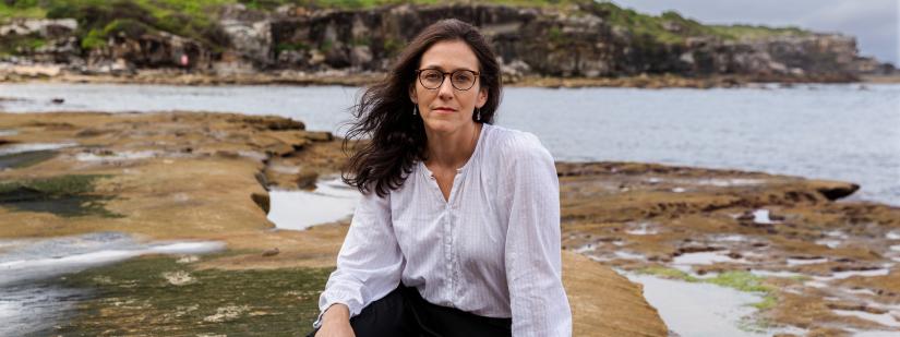 Eleanor sits by the ocean