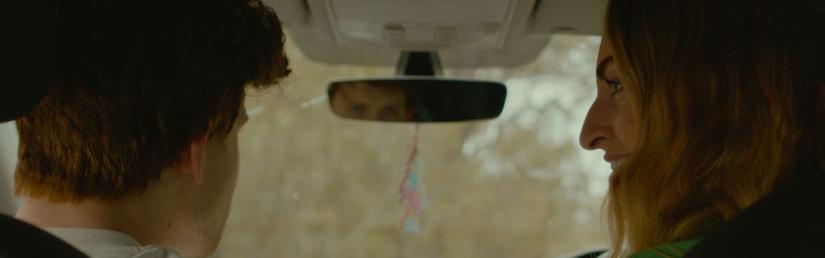 Still image from The Trip where two characters talk in the front seat of a car