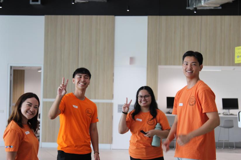 Four Peer Networkers smiling, standing in Building 2 at UTS.