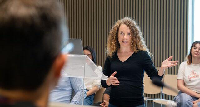 Image of a female Juris Doctor student presenting a case in a moot court
