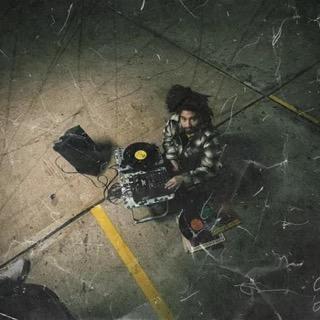 DJ spinning records in between yellow car park lines