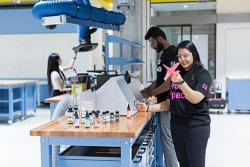 Three students at work in the UTS ProtoSpace