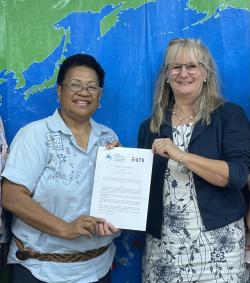 Two international colleagues at signing of document