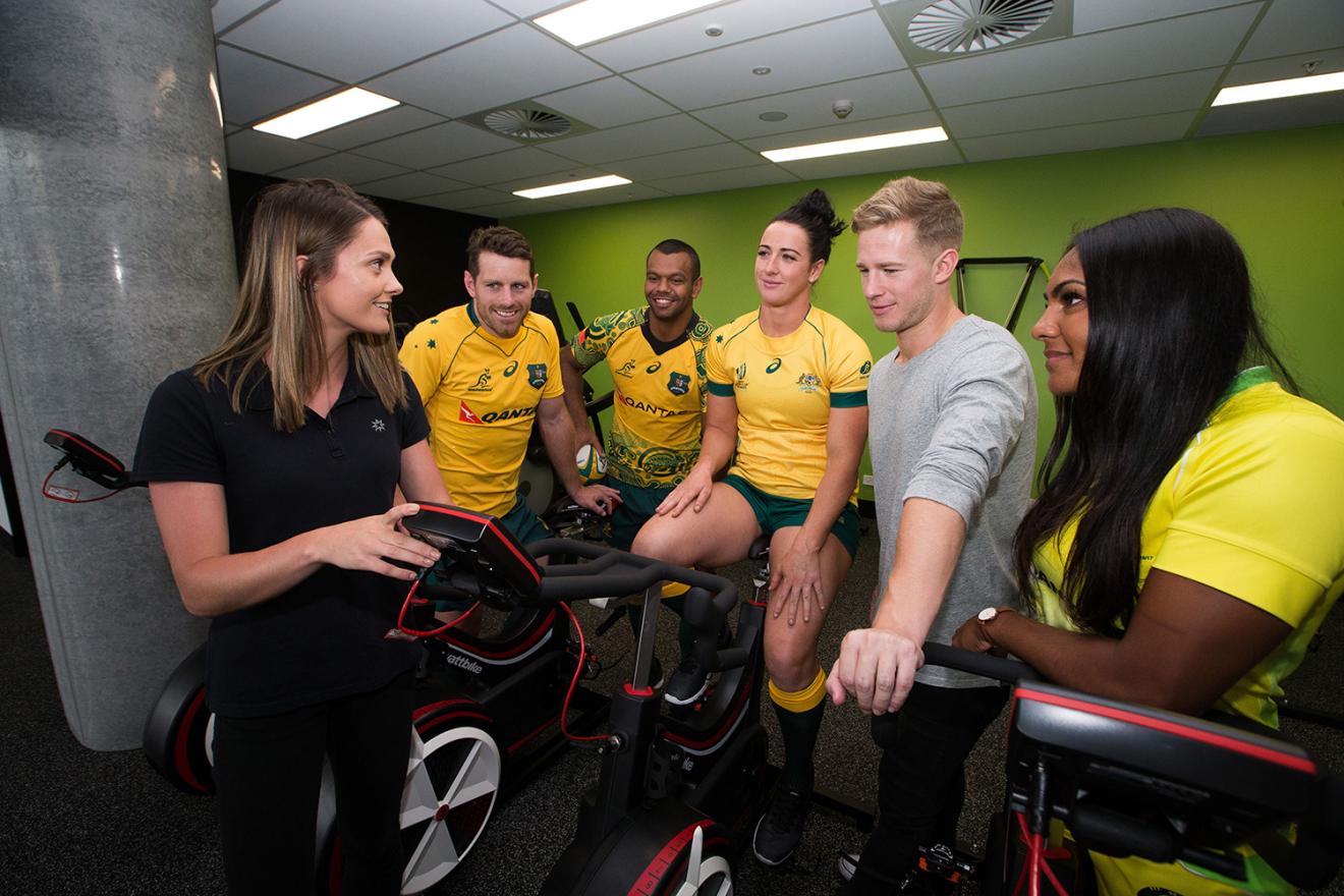 UTS staff with professional athletes on training bikes