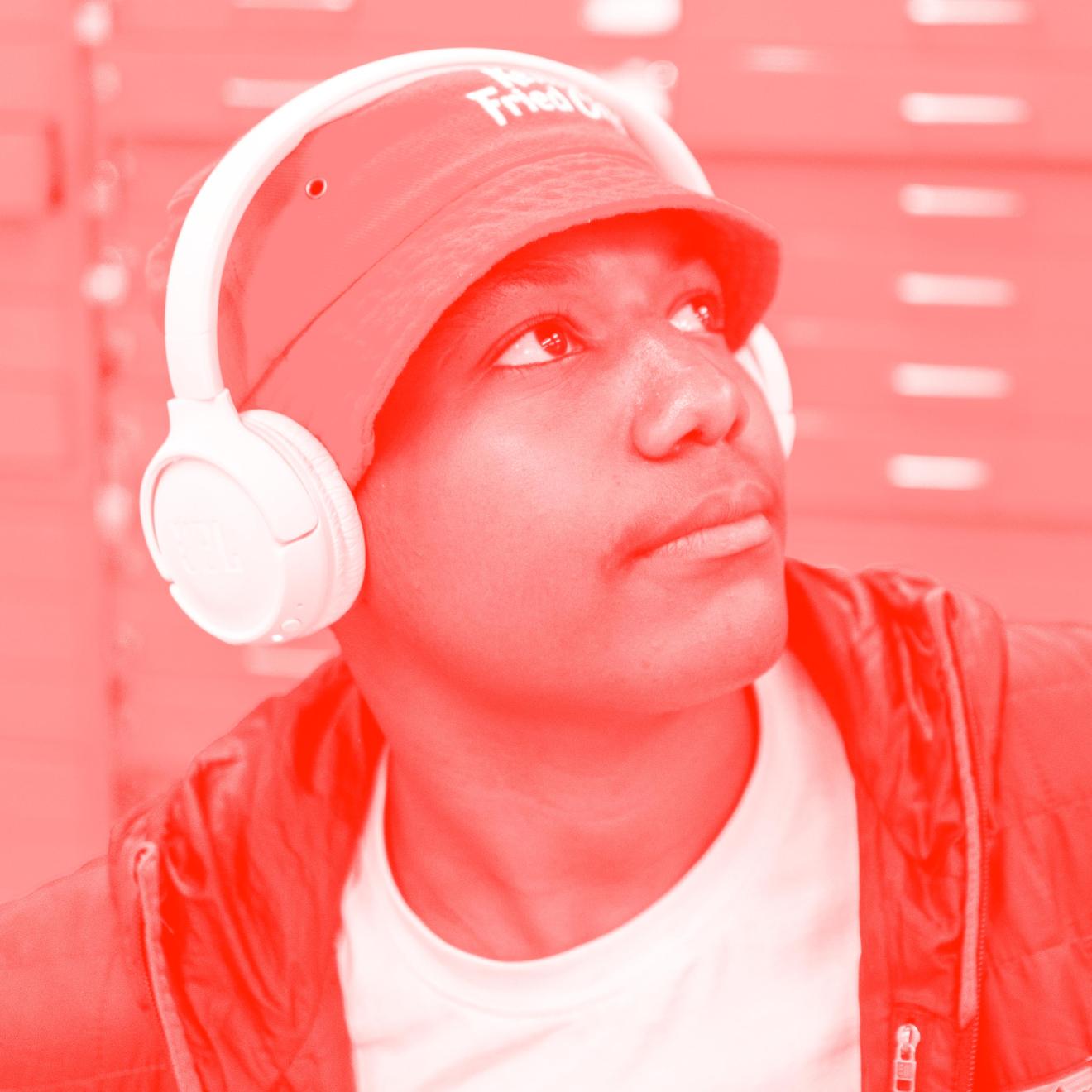 Male high school student wearing a bucket hat and headphones.