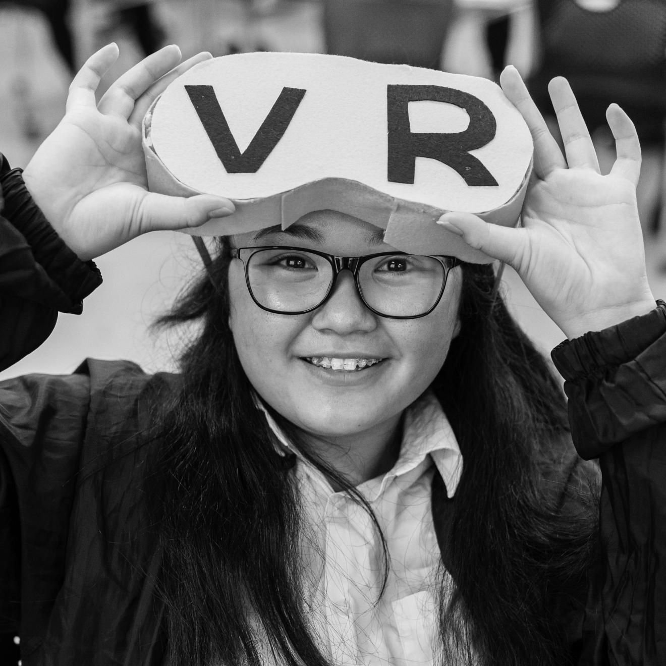 Female high school student wearing handmade virtual reality glasses.