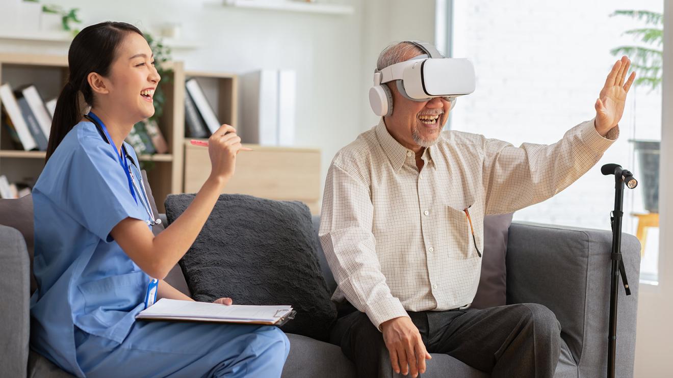 man with virtual reality headset laughs with nurse
