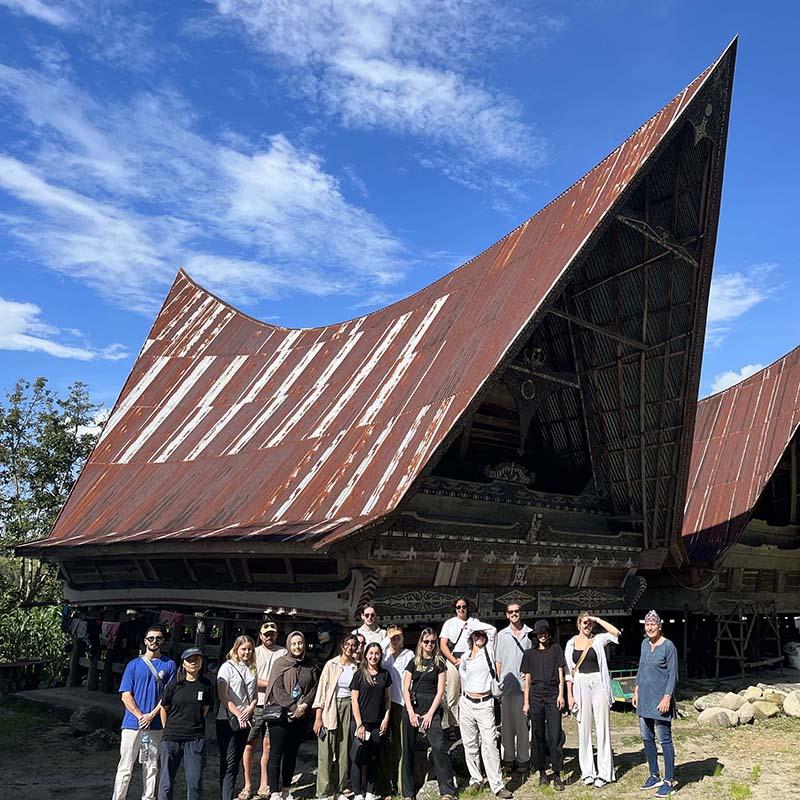 Group of people standing outside a building in Sumatra, Indonesia.