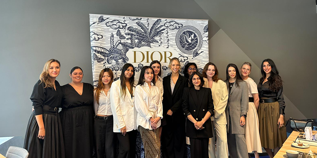 UTS women standing in a row in DIOR office