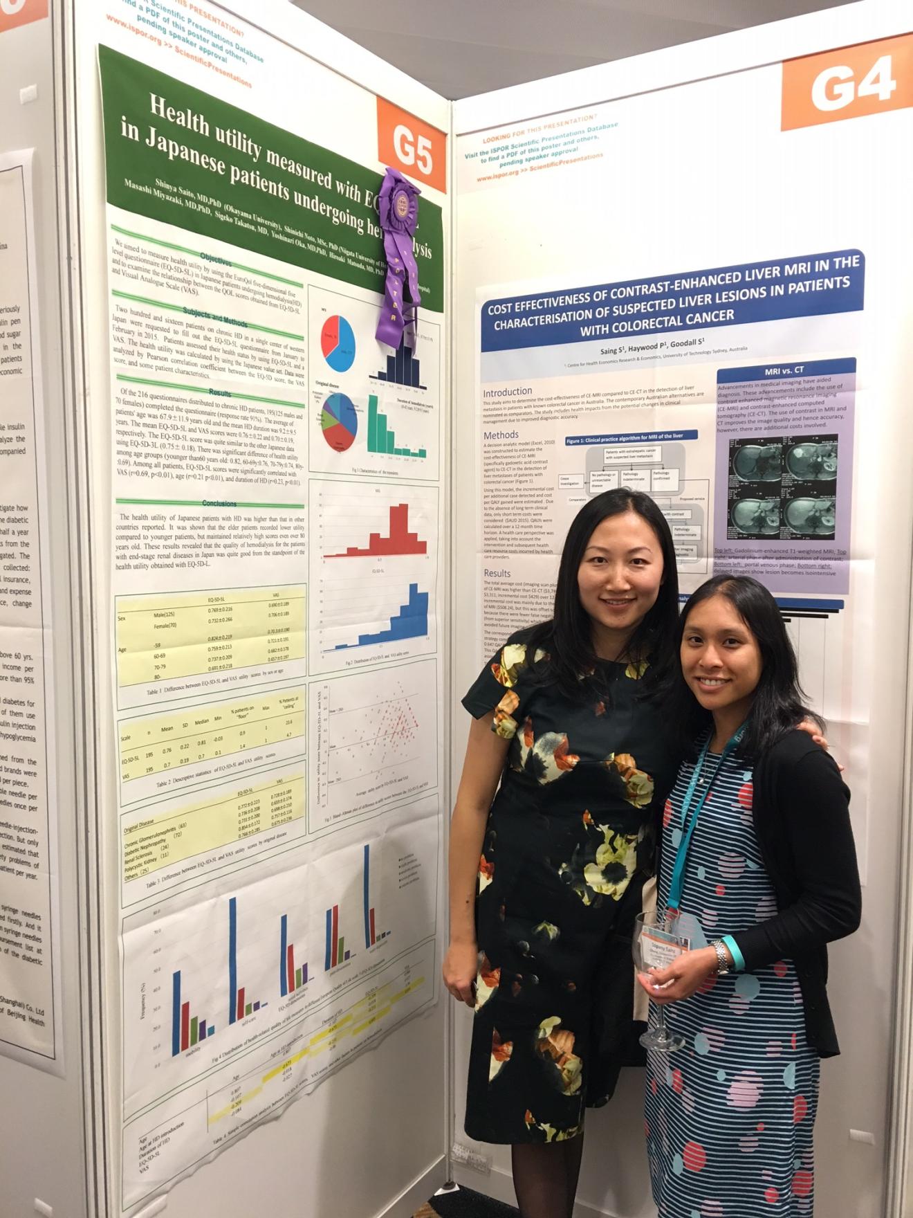 Fei-Li Zhao and Sopany Saing are standing in fornt of Sopany's poster at the conference
