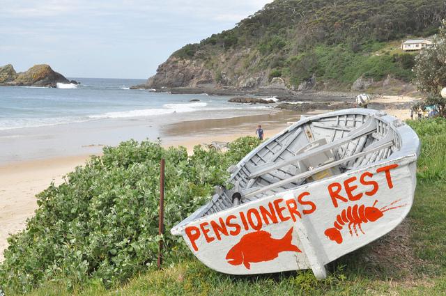 A boat with the name Pensioners Rest sits on a beach