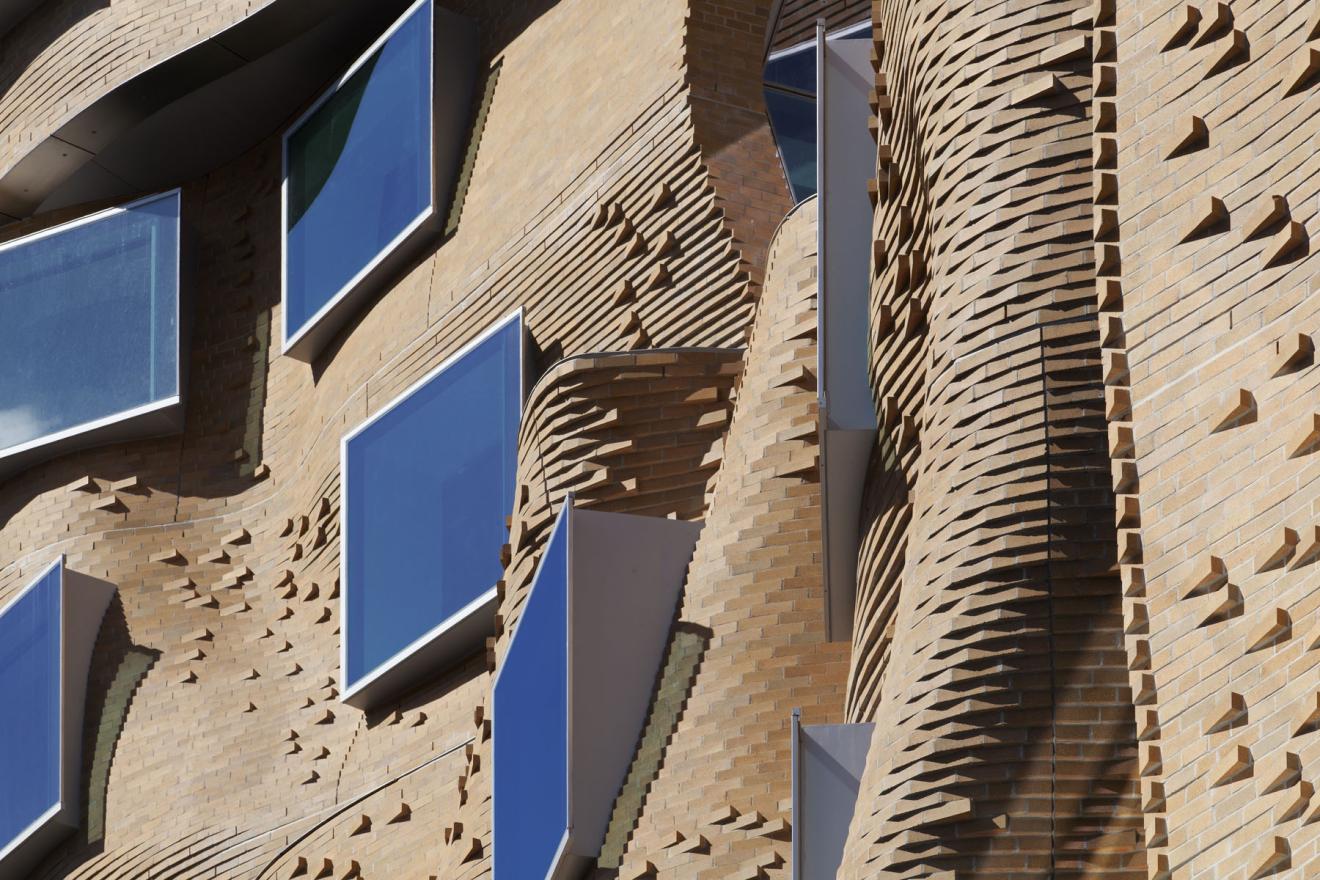 Mary Anne Street - North Canyon. Achieving the fluid appearance of the brickwork proved a technical feat that involved corbelling (stepping) individual bricks to articulate the building’s organic shape. The light-coloured bricks – around 320,000 in total