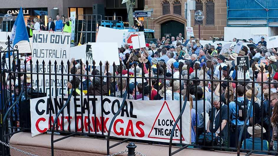 A crowd of people protesting against coal mining