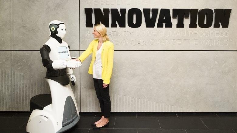 Photo of a woman being greeted by Chip Candroid
