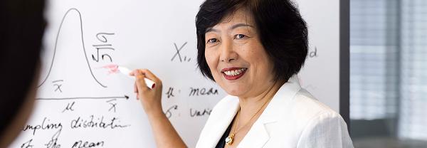 Distinguished Professor Jie Lu writing on a whiteboard