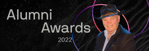 web banner image of Jack Beetson's headshot inset into a black web banner that reads 'Alumni Awards 2022'. Jack is wearing a wide brimmed black hat and smiling at the camera.
