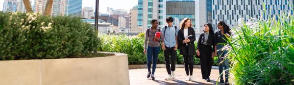 Five UTS international students walking on library balcony