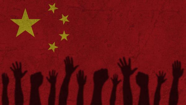 Protesters hands shadow on China flag