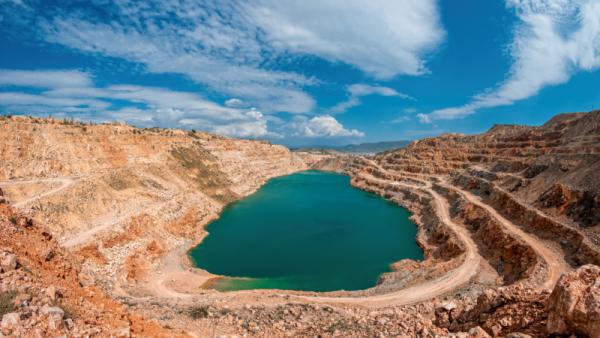 Oval lake in mining industrial crater