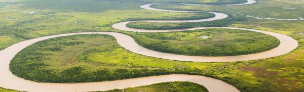 a spiraling river across green plains