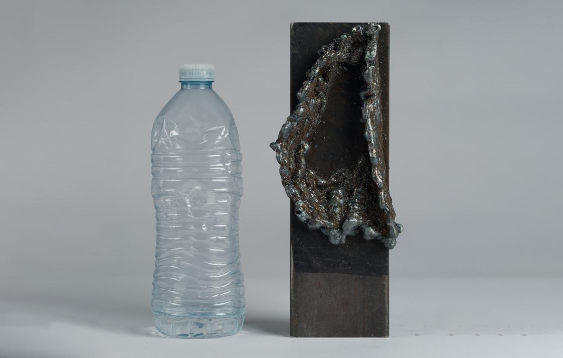 Welded artwork and plastic water bottle
