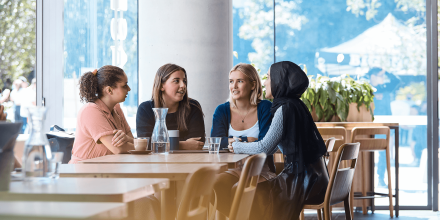 Four UTS students socialising on campus food court