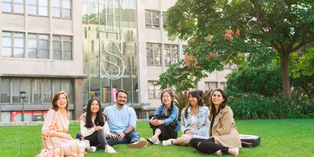 A group of UTS students sitting on the grass and socialising outside building 10